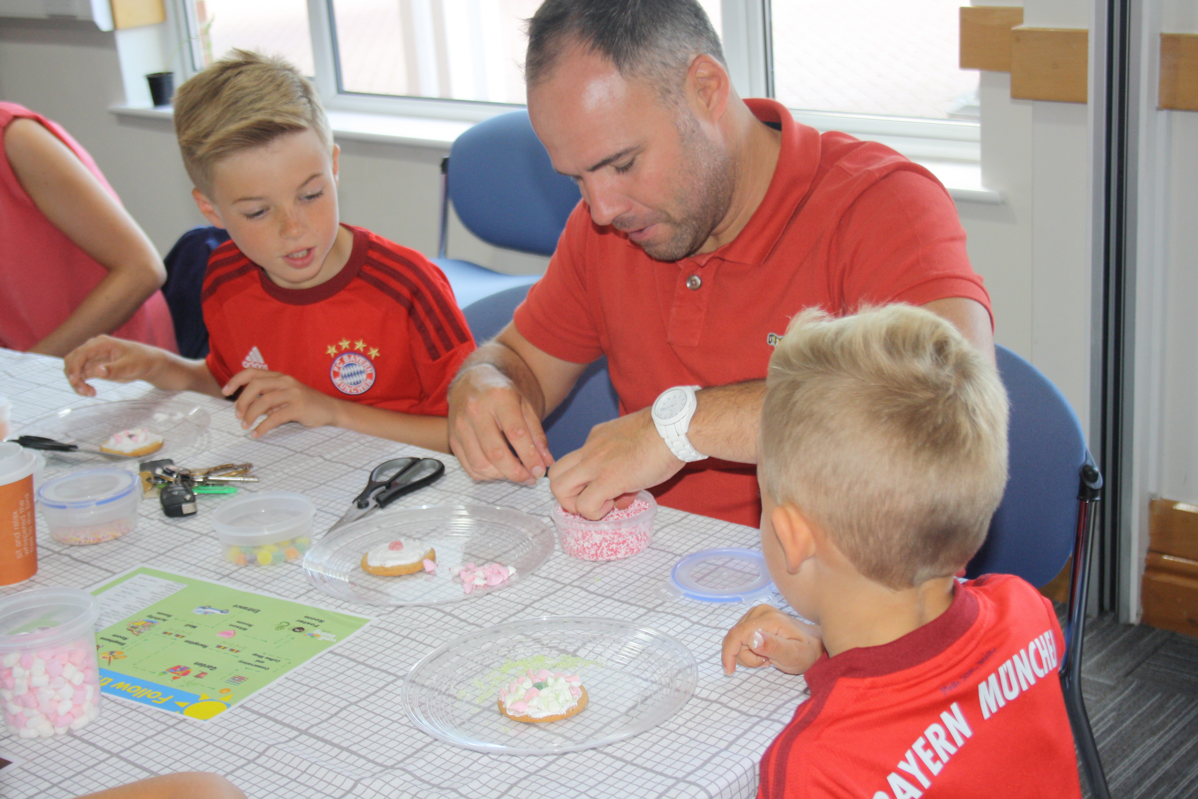 Family at Family Fun Day decorating biscuits